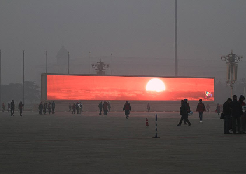 Beijing Citizens, Shrouded In Pollution, Flock To Giant Screens To View Artificial Sunrise